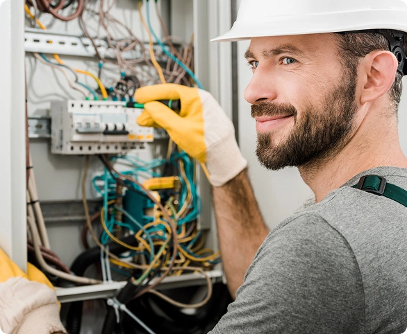 Electrician repairing electrical panel wiring