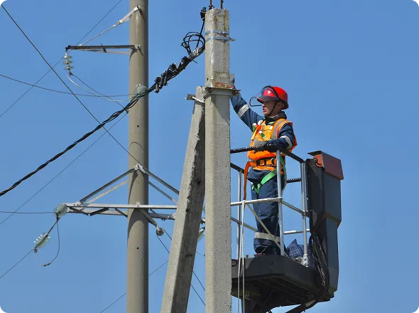 Electrician performing elevated farm electrical repairs using a bucket truck.